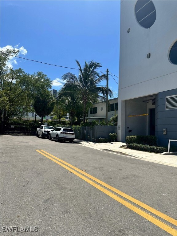View of asphalt street featuring sidewalks