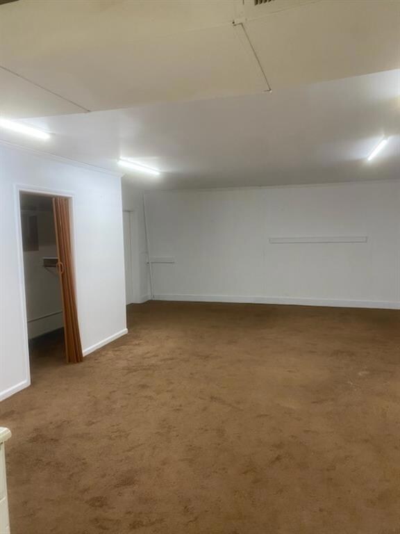 Basement featuring carpet floors and baseboards