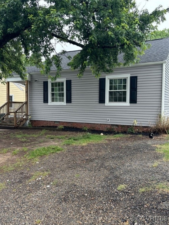 View of property exterior featuring roof with shin