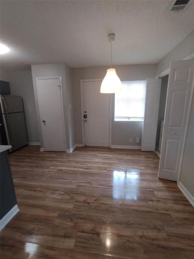Unfurnished dining area featuring a textured ceil