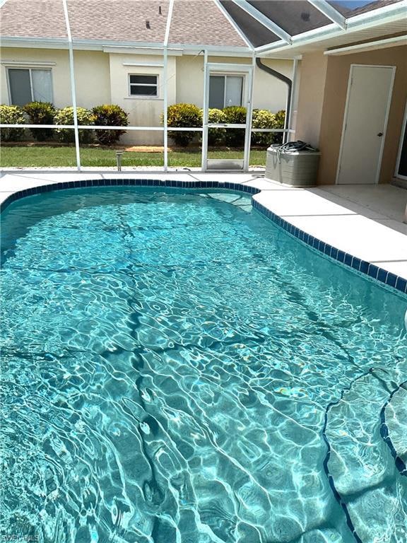 Outdoor pool with a lanai and a patio