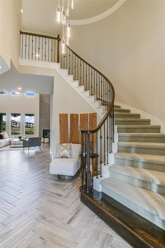 Stairs featuring a towering ceiling