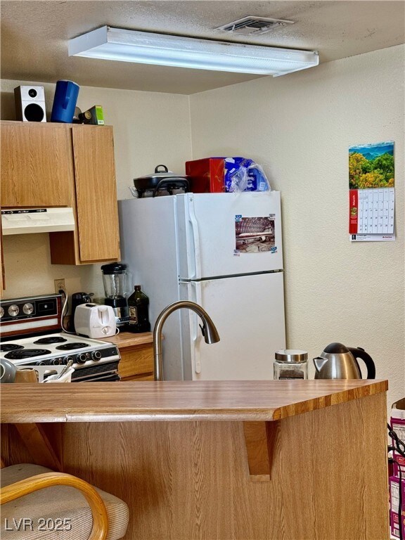 Kitchen featuring light countertops, a breakfast b