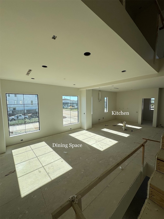 Open-concept design with seamless sightlines from the Staircase into the Dining area, Kitchen, and Living Room.