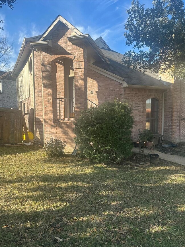 View of side of home featuring a yard