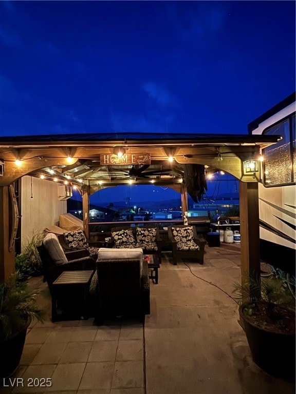 Patio at night featuring an outdoor living space