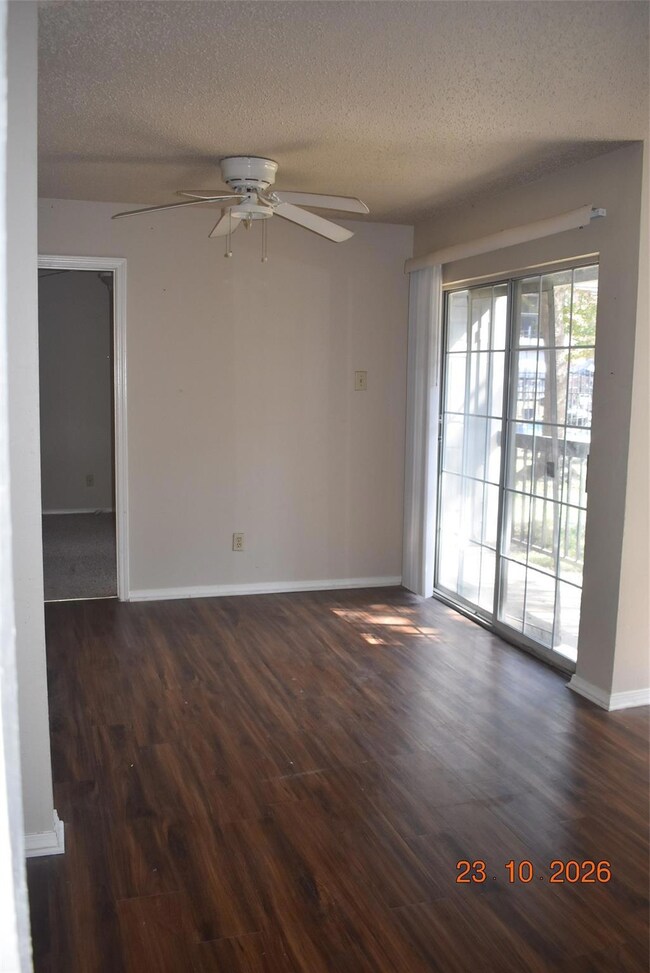 Unfurnished room with ceiling fan, a textured ceil