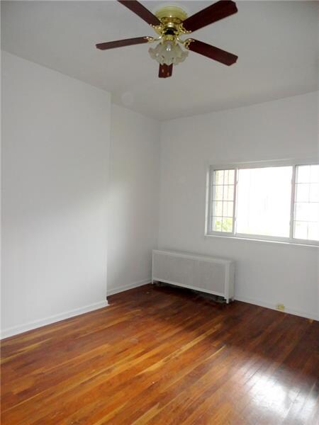 LIVINGROOM WITH EXPOSED WOOD FLOORING.