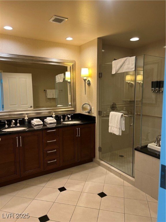 Full bathroom featuring double vanity, a shower st