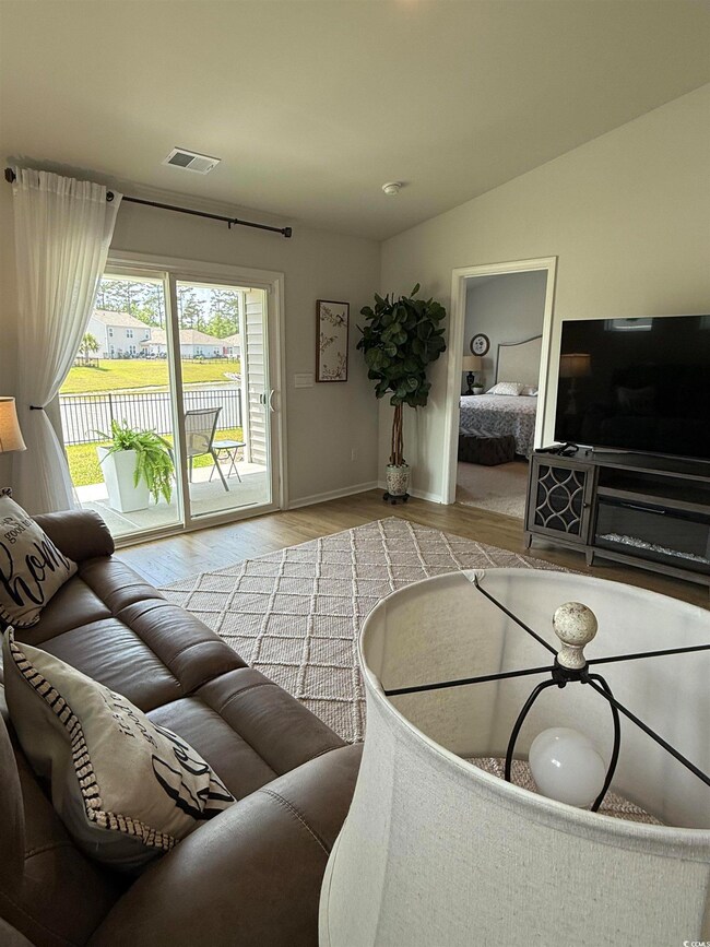 Living area with wood finished floors and baseboar