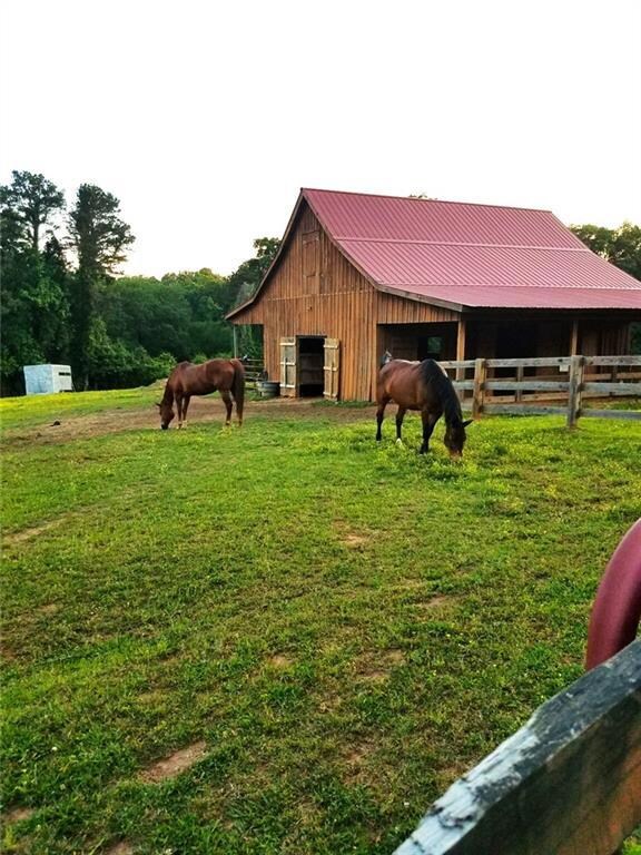 Equestrian Barn is equipped with water, hose for washing horses, power, and 5 stalls.