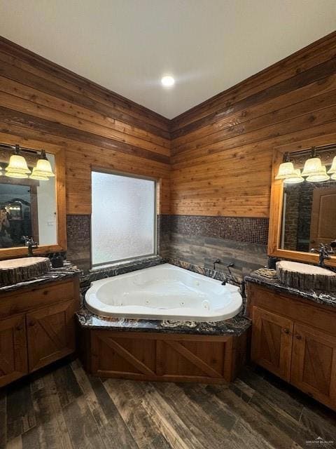 Bathroom featuring wood-type flooring, vanity, and wood walls