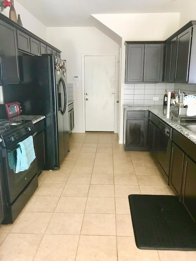 Kitchen with light tile patterned flooring, light
