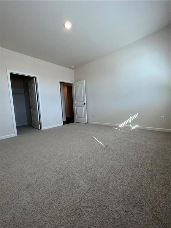 Unfurnished bedroom featuring carpet floors and ba