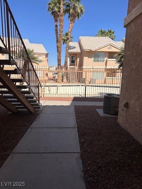 View of yard with stairs, central air condition un