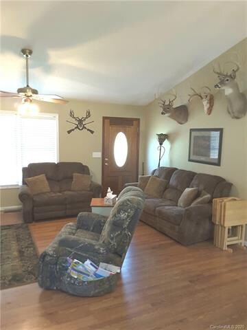 Open kitchen/den/dining floor plan with a vaulted 