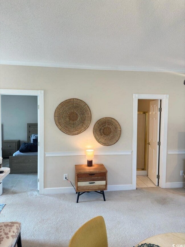 Living room with a textured ceiling, crown molding