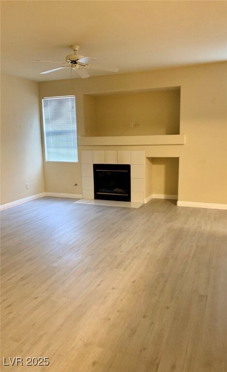 Unfurnished living room featuring a tile fireplace