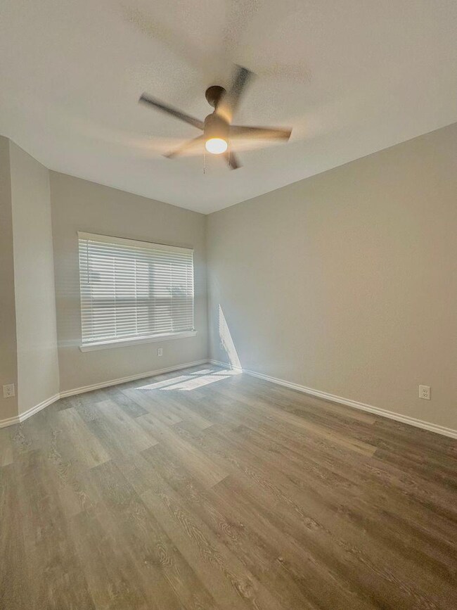Spare room featuring wood finished floors and ceiling fan