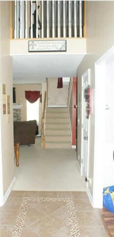 Welcoming foyer with custom tile floor.