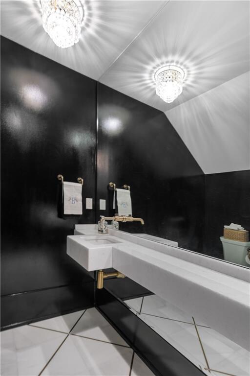 Powder Room off of the foyer features chic modern