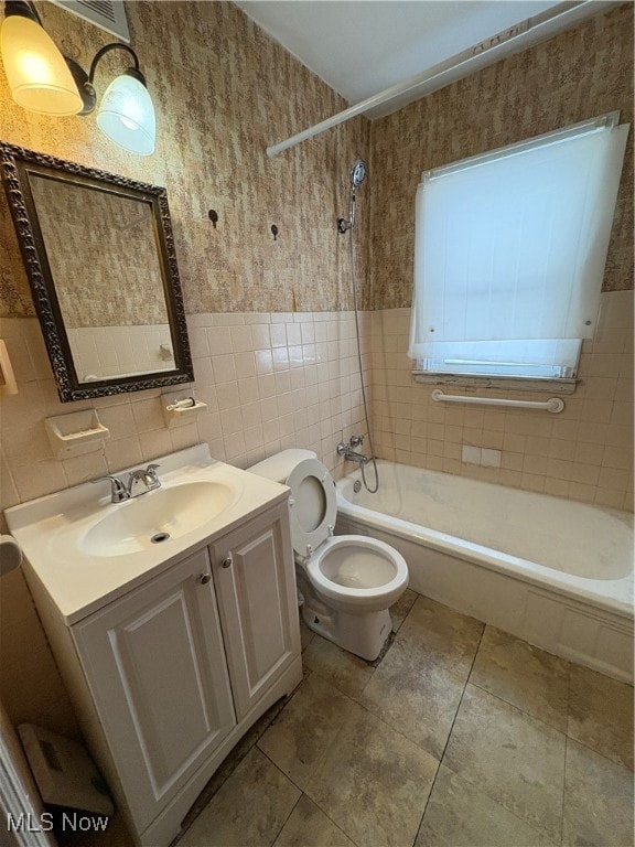 Full bath with vanity, tile walls, bathtub / shower combination, wallpapered walls, and light tile patterned floors