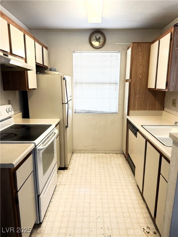 Kitchen featuring white range with electric cookto