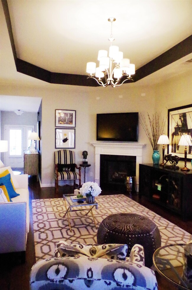 From foyer right into the gathering room.  This area has been decorated with colors that are very cool and light.  The tv mounted over the fireplace gives this room a formal look as does the decorations.  Great size room.  Opens into kitchen area