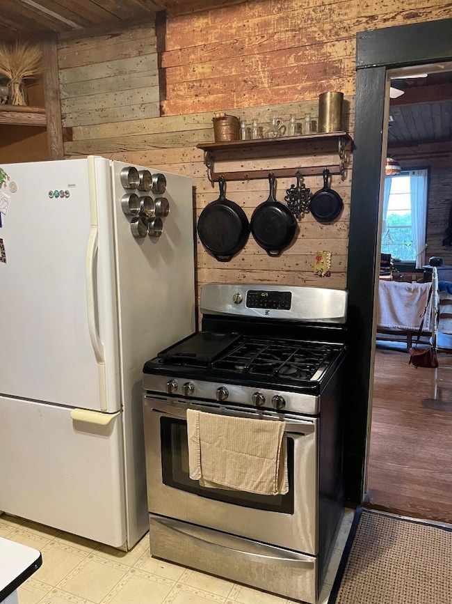 Kitchen with stainless steel range with gas stove