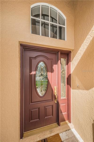 Very inviting designer glass front door.