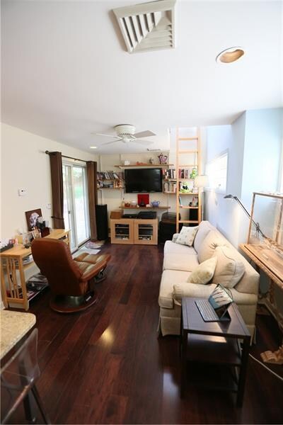 Den with custom ladder leading to loft.