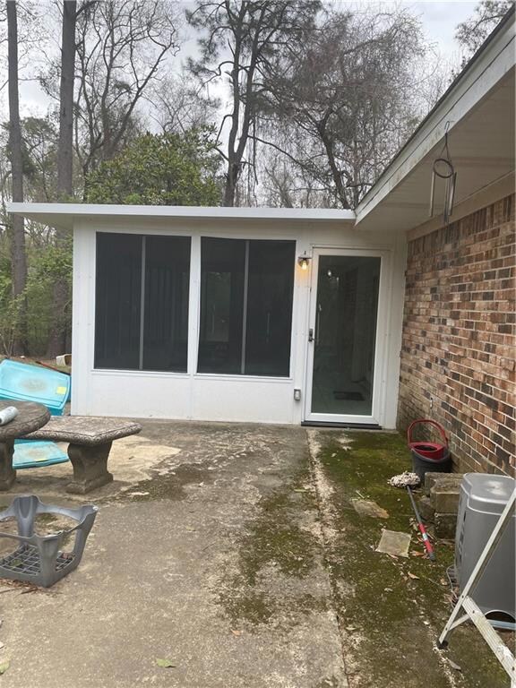 View of exterior entry featuring a patio area and 