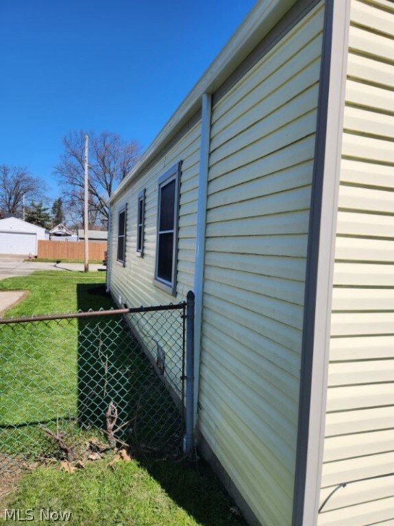 View of side of home featuring a lawn