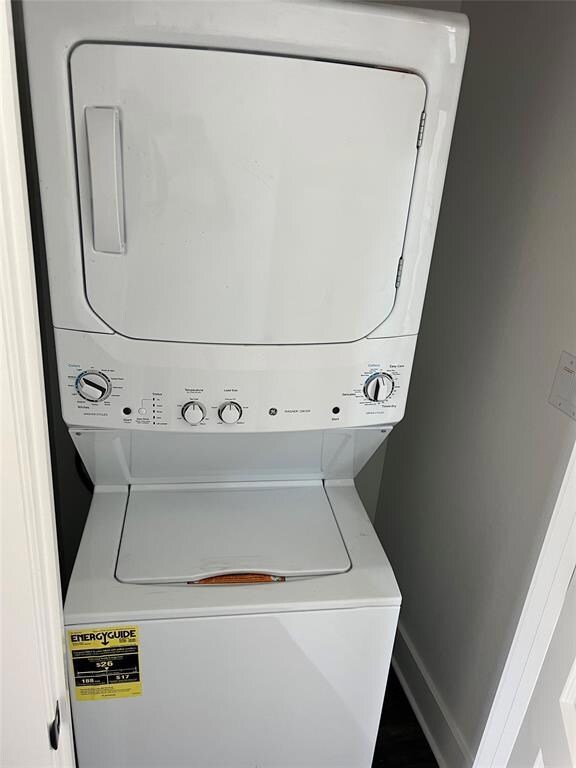 Laundry room featuring stacked washer and clothes