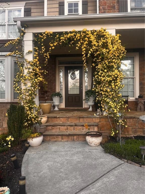 View of exterior entry featuring covered porch