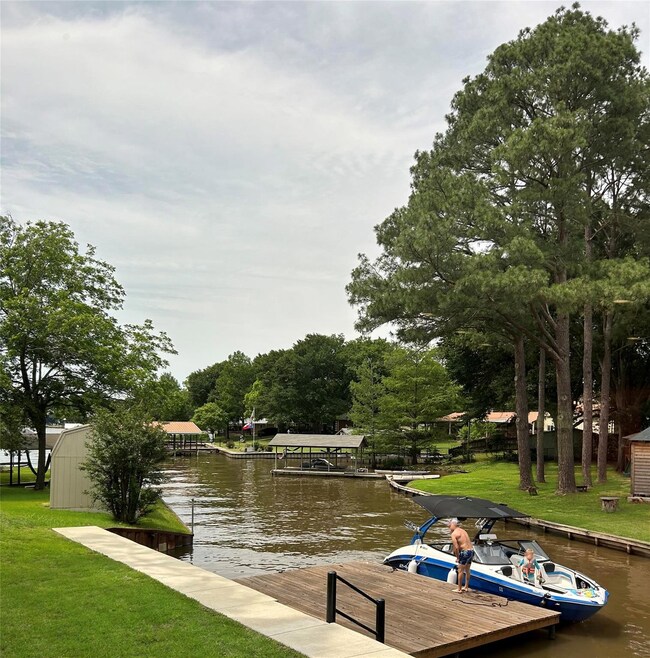 Dock area featuring a lawn and a water view