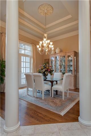 The formal dining room is located conveniently off the kitchen to make entertaining a breeze. The beautiful trey ceilings, columns and French doors make this room a show-stopper.