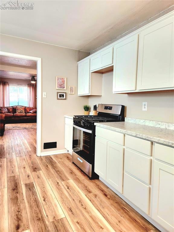 Kitchen featuring light wood-style flooring, gas s