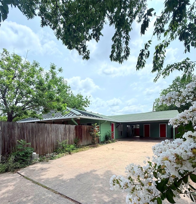 View of front of house with driveway and an attac