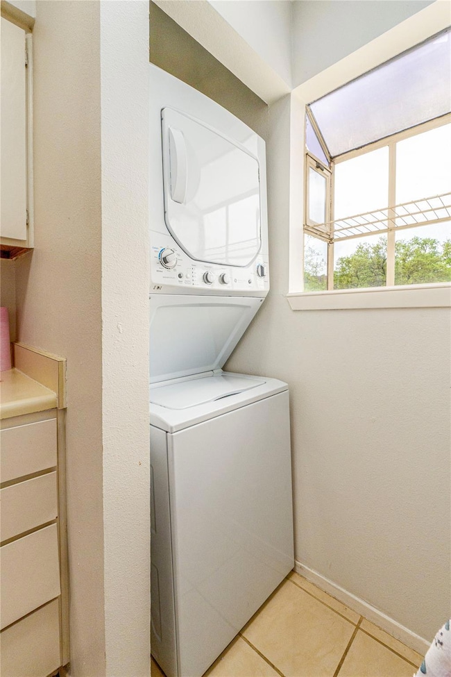 Washroom with stacked washer and clothes dryer an