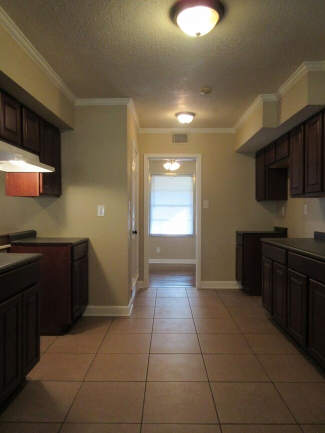 Kitchen featuring light tile patterned floors, a t