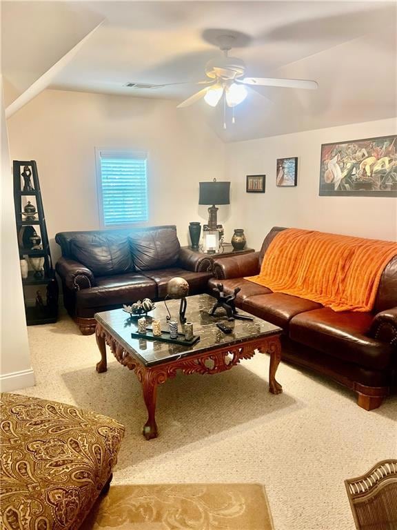Living area featuring a ceiling fan, carpet, and l