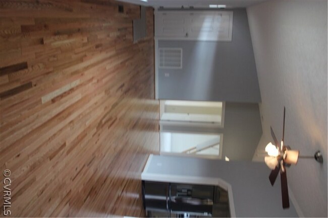 Family room with gorgeous wood floors, vaulted cei