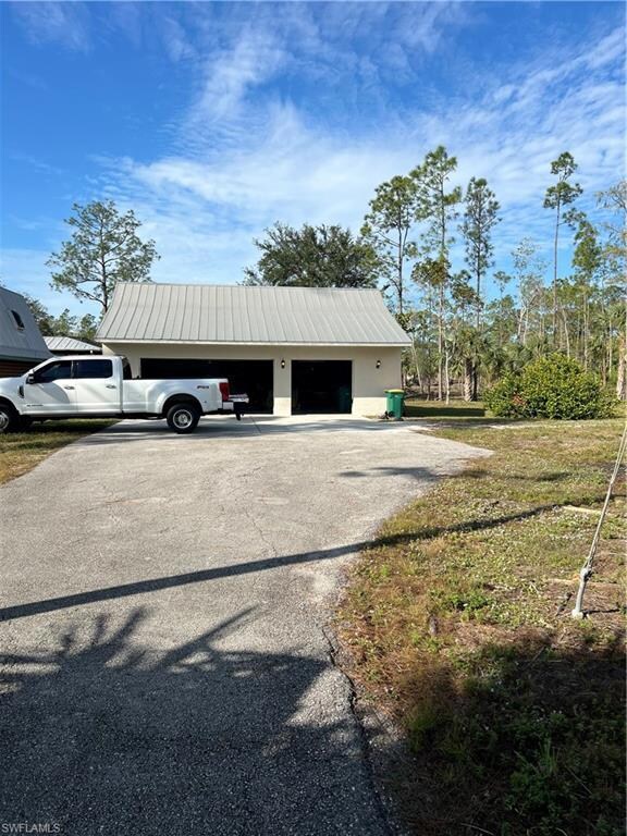 View of outdoor structure with a garage