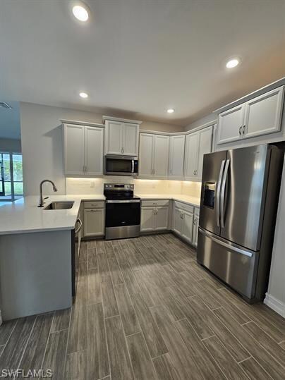 Kitchen with appliances with stainless steel finis