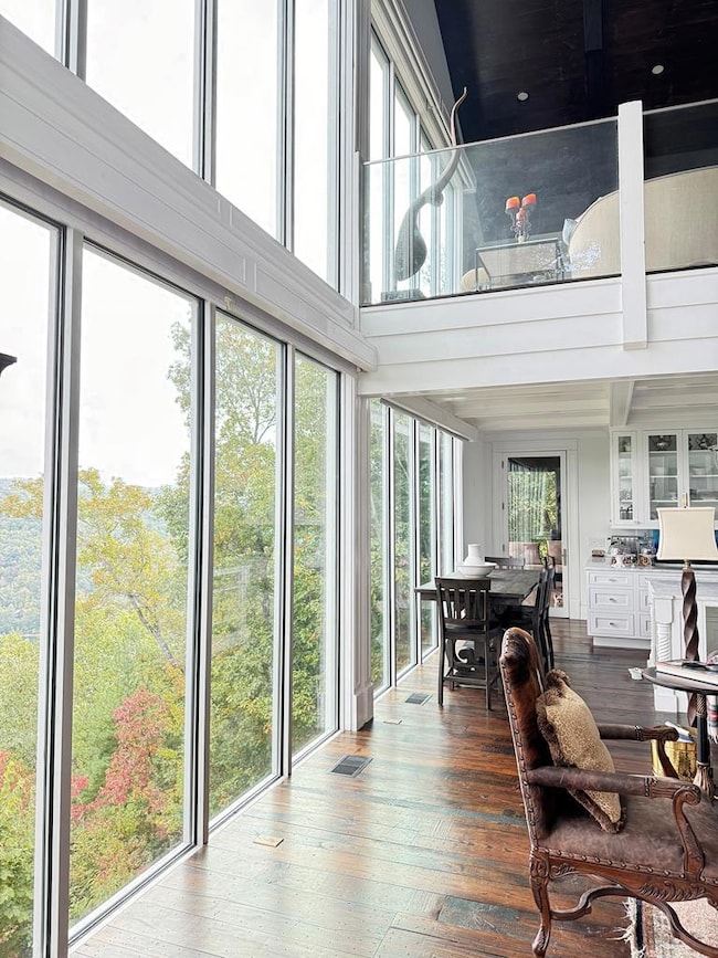 WALL OF WINDOWS LOOKING TO THE KITCHEN AND PORCH