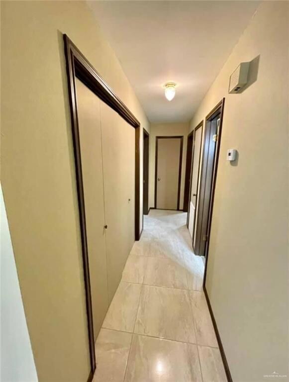 Hallway with light tile flooring