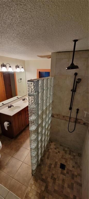 Double sinks and glass bloock shower wall.