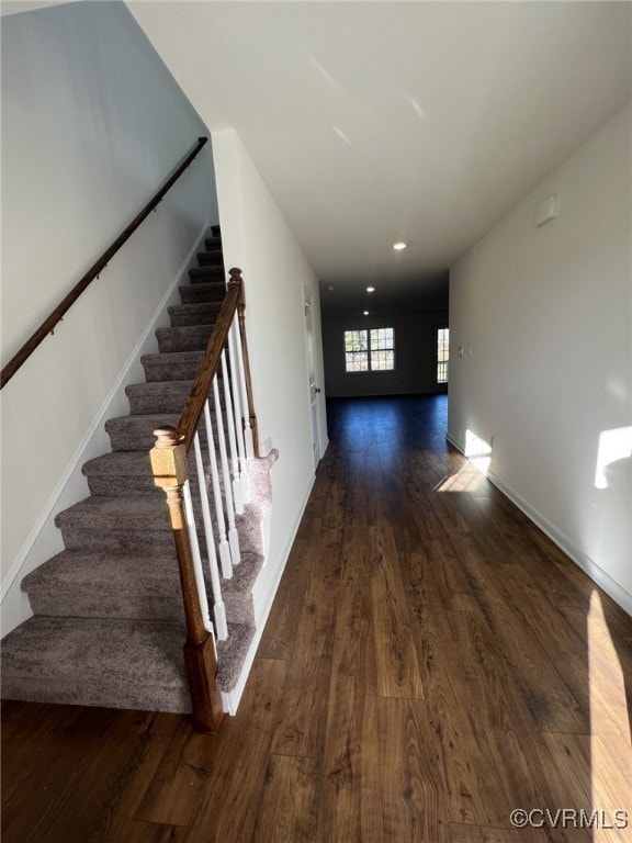 Foyer featuring stairs, dark wood finished floors,