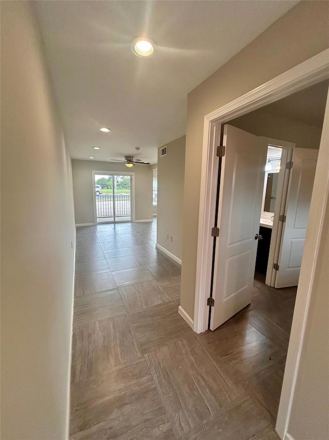 Hall featuring baseboards and recessed lighting